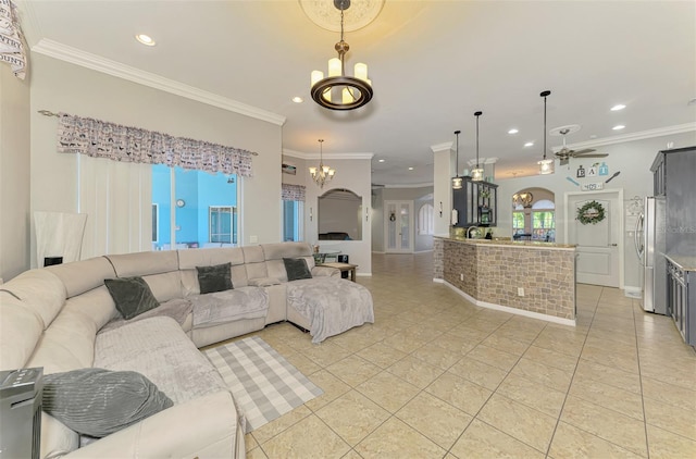 living room with arched walkways, light tile patterned floors, and crown molding