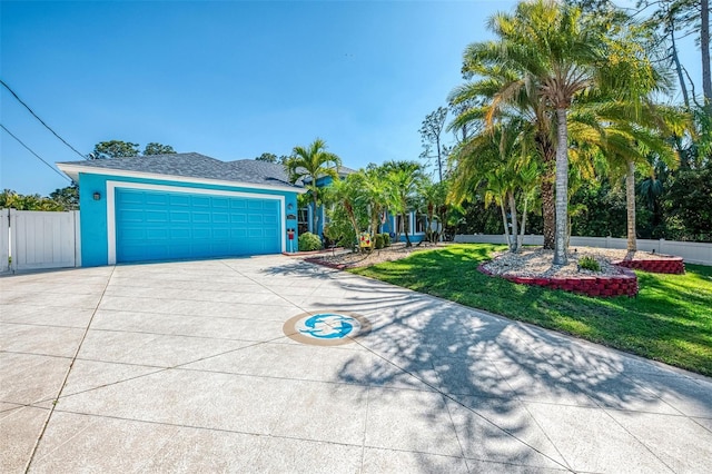 view of front of property with stucco siding, concrete driveway, a front yard, and fence