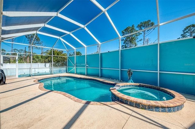 view of pool with glass enclosure, a patio, fence, and a pool with connected hot tub