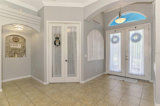 foyer entrance with french doors, crown molding, and baseboards