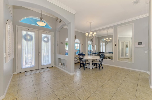 entryway with tile patterned flooring, visible vents, an inviting chandelier, and ornamental molding