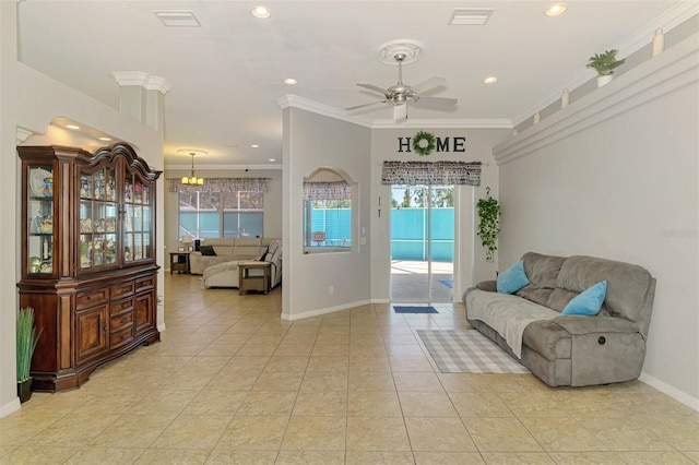 living area with a wealth of natural light, visible vents, crown molding, and baseboards