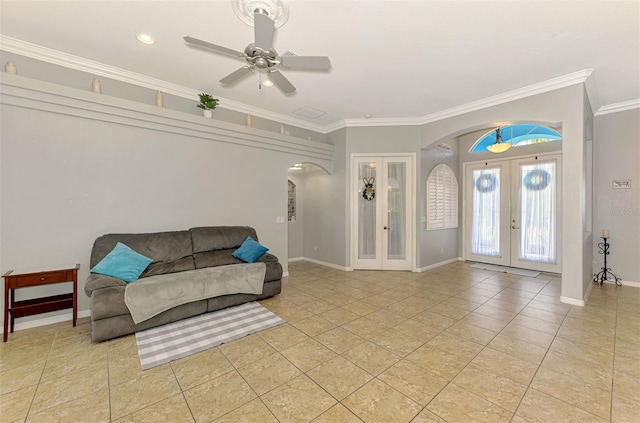 interior space featuring french doors, arched walkways, crown molding, light tile patterned floors, and baseboards