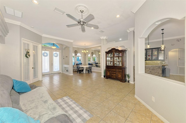 living area with light tile patterned floors, visible vents, french doors, and ornamental molding