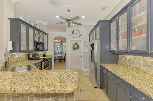 kitchen with visible vents, a sink, arched walkways, appliances with stainless steel finishes, and crown molding