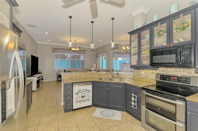 kitchen featuring light tile patterned floors, a peninsula, a sink, ornamental molding, and stainless steel appliances