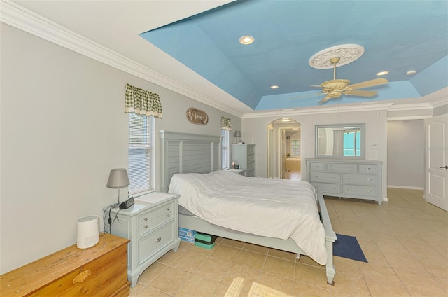 bedroom featuring arched walkways, recessed lighting, a raised ceiling, and ornamental molding