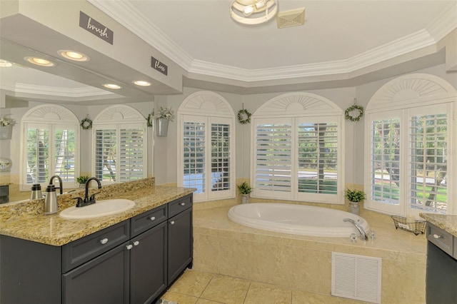 full bathroom with a wealth of natural light, visible vents, vanity, and a bath