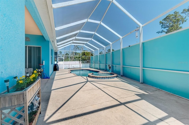 view of swimming pool with glass enclosure, a patio area, and a pool with connected hot tub