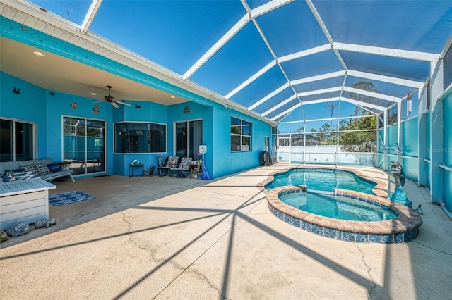 view of swimming pool with a patio area, a pool with connected hot tub, a lanai, and ceiling fan