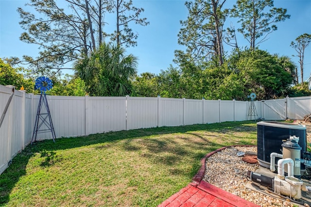 view of yard featuring central AC and a fenced backyard