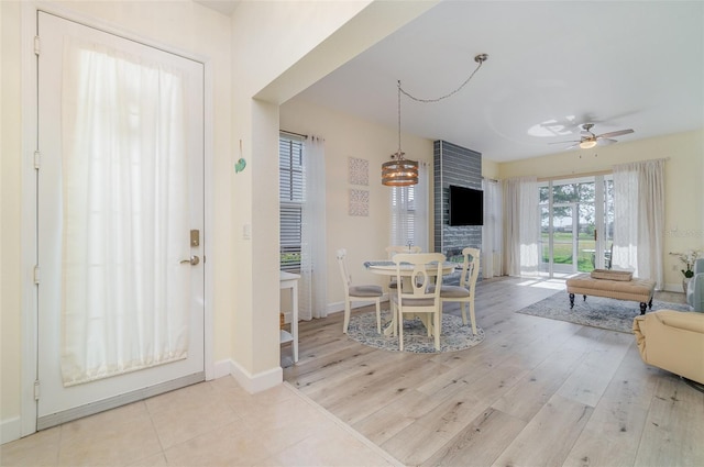 dining room with baseboards, light wood-style floors, and ceiling fan