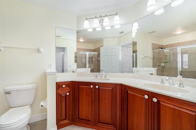 bathroom featuring double vanity, visible vents, a stall shower, and a sink