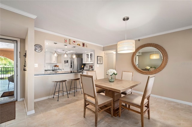 dining room featuring baseboards and ornamental molding