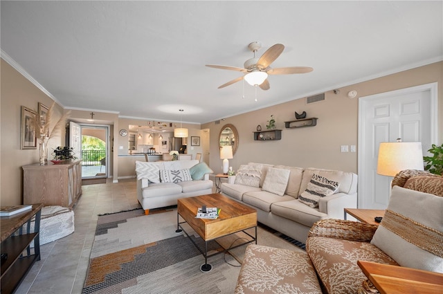 tiled living room with visible vents, crown molding, and ceiling fan