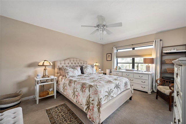 bedroom with a ceiling fan, baseboards, and carpet floors