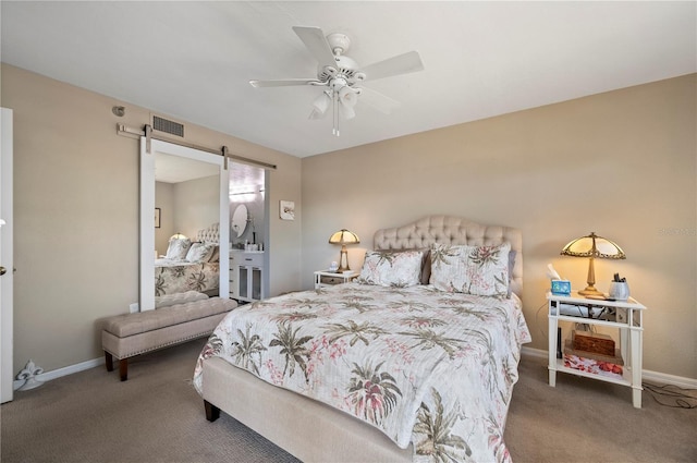 bedroom featuring visible vents, carpet floors, baseboards, and a barn door