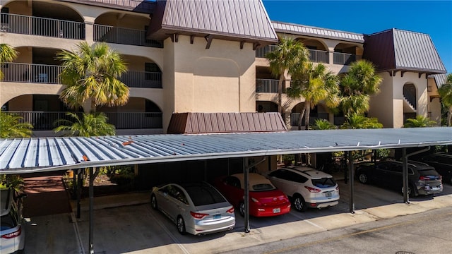 view of building exterior featuring covered parking