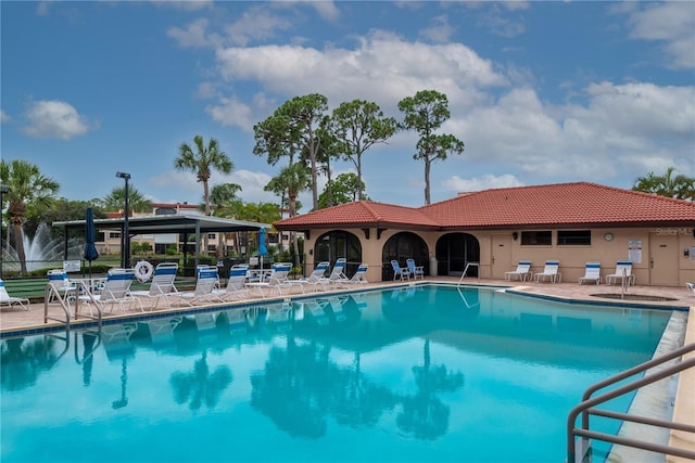 pool featuring a patio area and fence