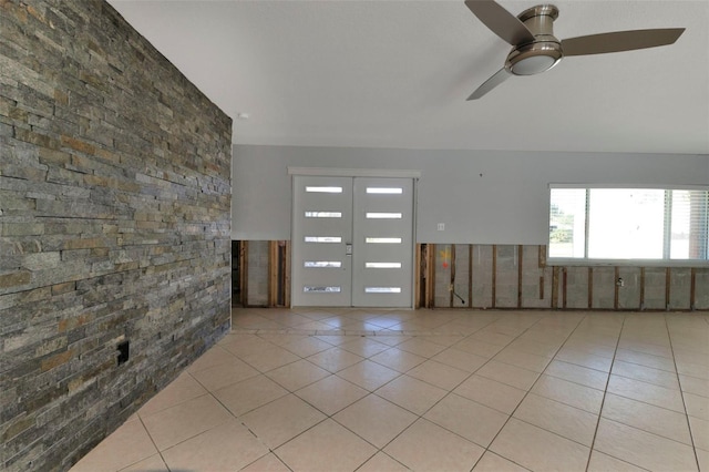 interior space with a ceiling fan and tile patterned floors