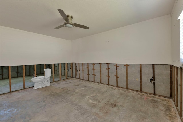 empty room featuring concrete flooring, crown molding, and a ceiling fan