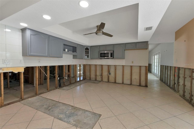 unfurnished room featuring light tile patterned floors, recessed lighting, a raised ceiling, visible vents, and ceiling fan