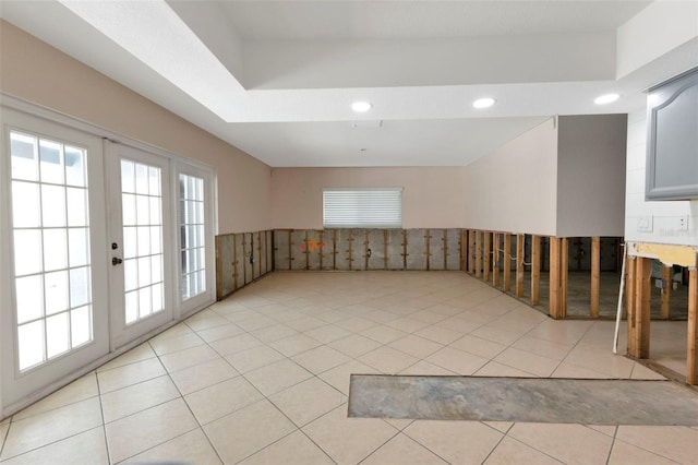 empty room featuring light tile patterned floors, recessed lighting, and french doors