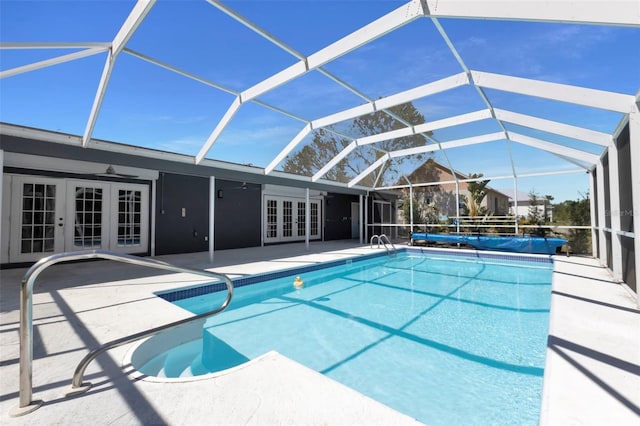 outdoor pool featuring french doors, a patio area, ceiling fan, and a lanai