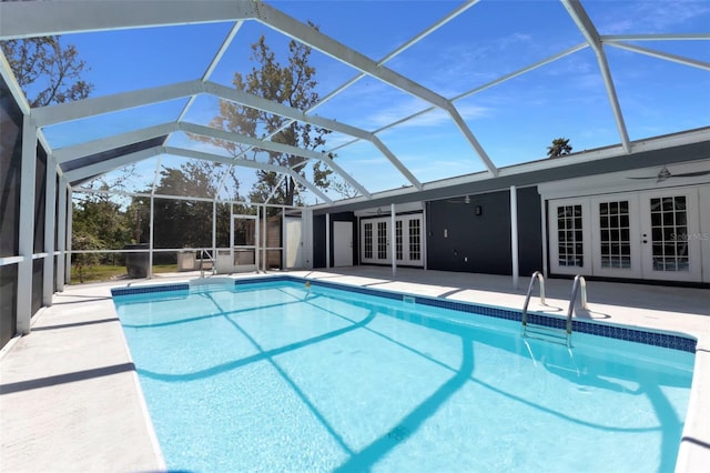 outdoor pool featuring a patio, french doors, a lanai, and a ceiling fan