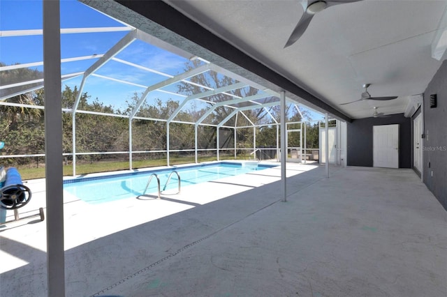 pool with a ceiling fan, glass enclosure, and a patio area