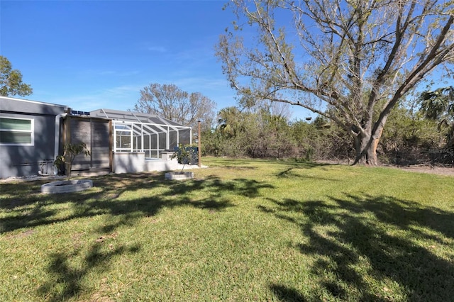 view of yard with glass enclosure