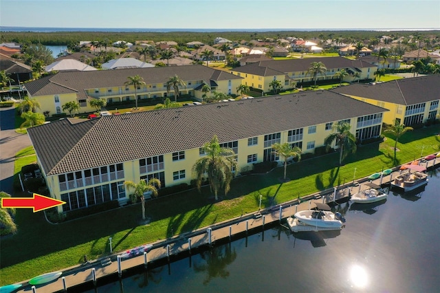 drone / aerial view with a water view and a residential view