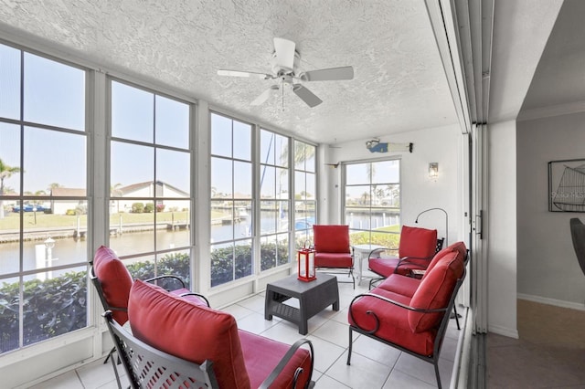 sunroom with a water view and ceiling fan