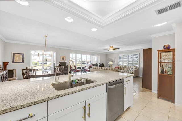 kitchen featuring light stone counters, a sink, visible vents, stainless steel dishwasher, and crown molding