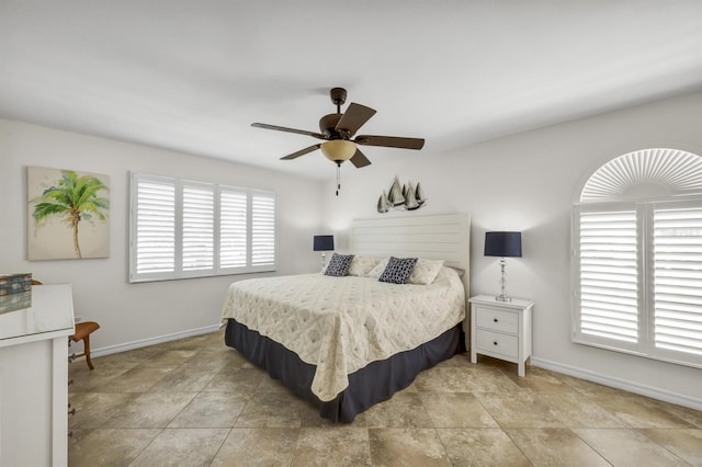 bedroom with ceiling fan and baseboards