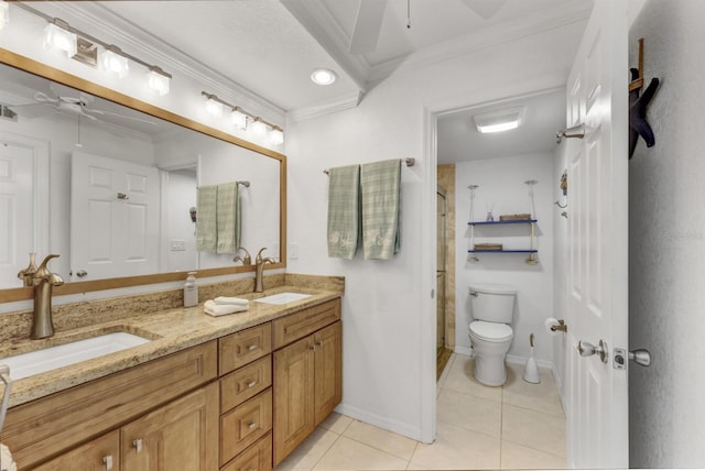 bathroom with toilet, tile patterned flooring, crown molding, and a sink