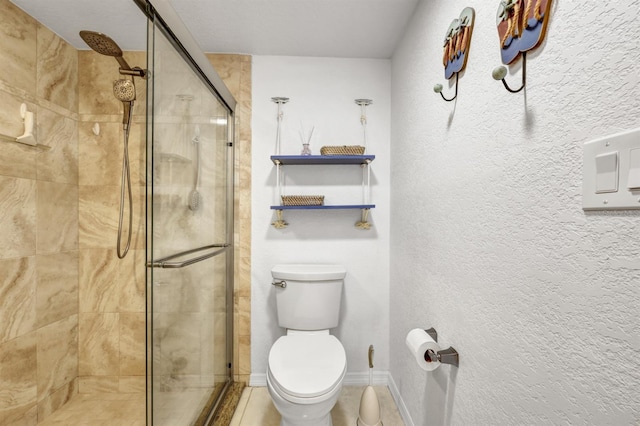 full bath with toilet, a stall shower, baseboards, and a textured wall