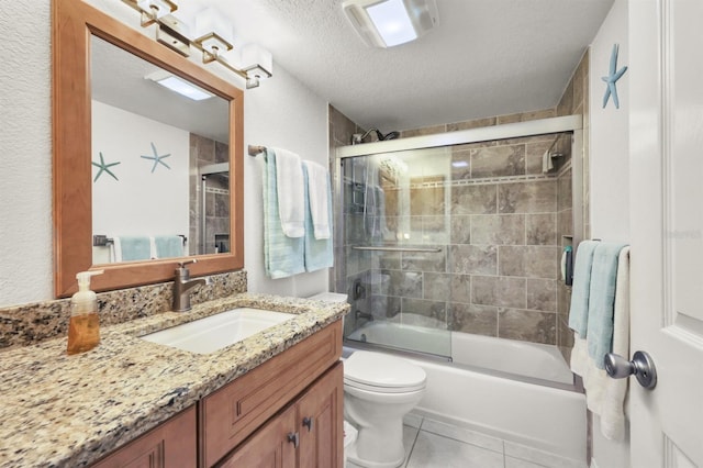 bathroom featuring a textured ceiling, tile patterned flooring, toilet, bath / shower combo with glass door, and vanity