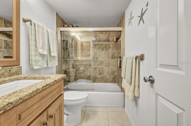 bathroom featuring toilet, combined bath / shower with glass door, a textured ceiling, vanity, and tile patterned flooring