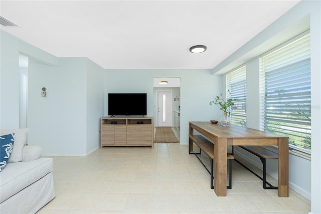 interior space with visible vents, baseboards, and light tile patterned floors