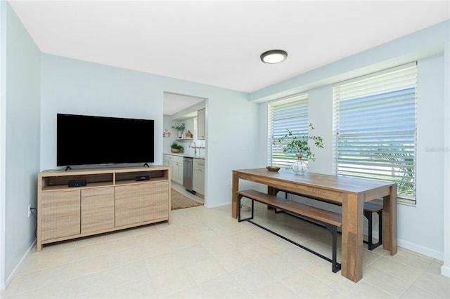 dining area with baseboards and light tile patterned floors