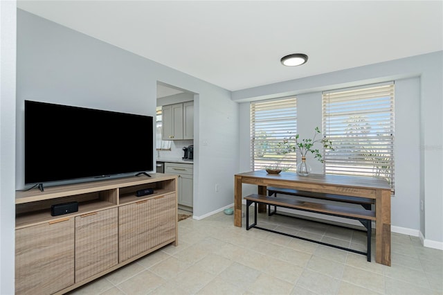 kitchen with gray cabinetry, light countertops, baseboards, and light tile patterned floors