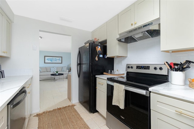 kitchen with backsplash, appliances with stainless steel finishes, light tile patterned flooring, light stone countertops, and under cabinet range hood