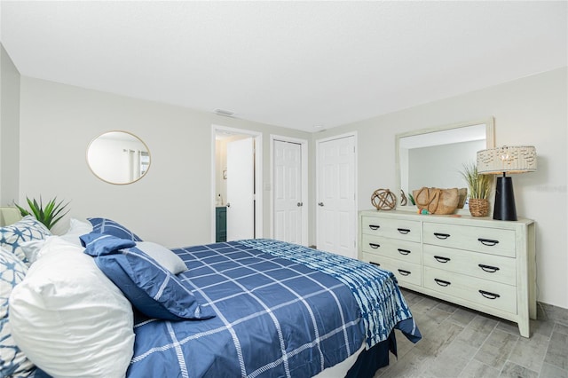 bedroom featuring light wood-type flooring and visible vents