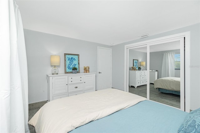 bedroom featuring wood finished floors and visible vents