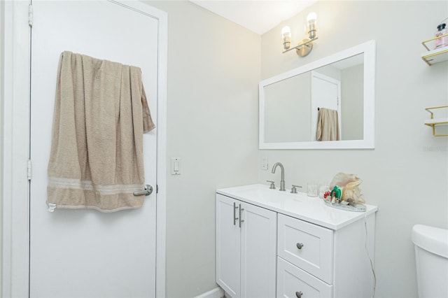 bathroom with toilet and vanity