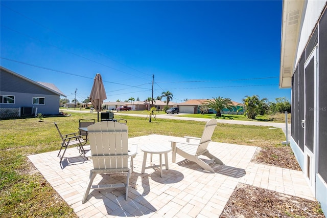 view of patio featuring outdoor dining space and central AC