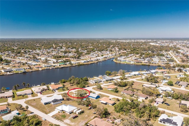 drone / aerial view with a water view and a residential view