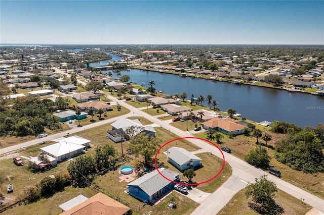 birds eye view of property featuring a water view and a residential view