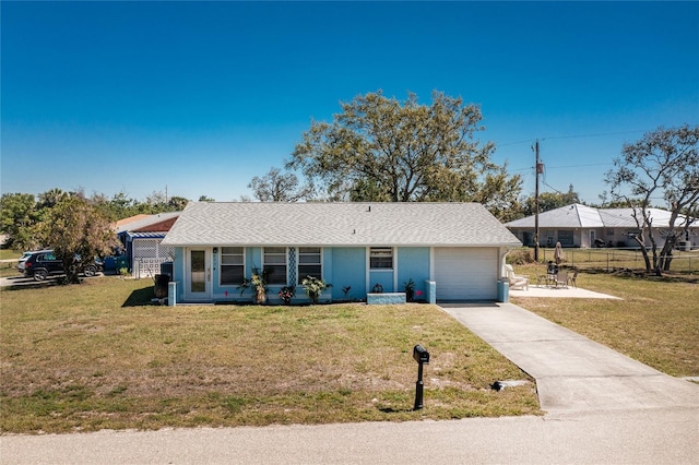 single story home with a garage, driveway, and a front lawn